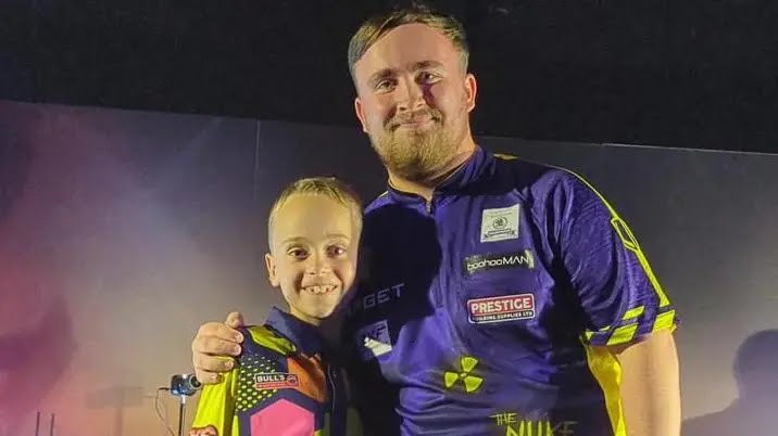 Darts prodigy, eight, beats champion Luke Littler